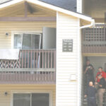 Police investigators stand outside the the second floor an apartment at 3703 W. Kennewick Ave during their search for clues into the death of Brandy Ebanez. Her body was found Sept. 27 in the Columbia River downstream of the cable bridge by a fisherman.